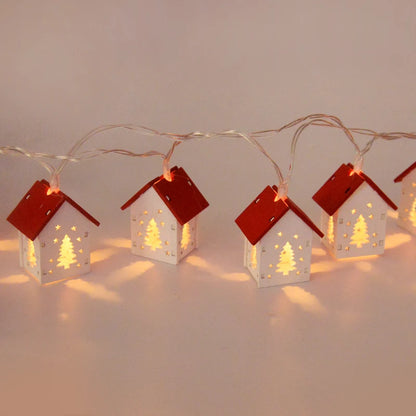 White wooden house red roof Christmas lights